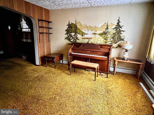 misc room featuring a drop ceiling, a baseboard heating unit, and carpet flooring