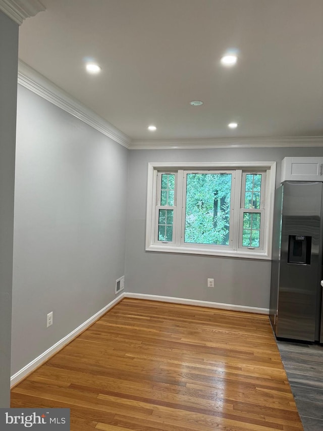 interior space featuring wood-type flooring, a fireplace, and ornamental molding