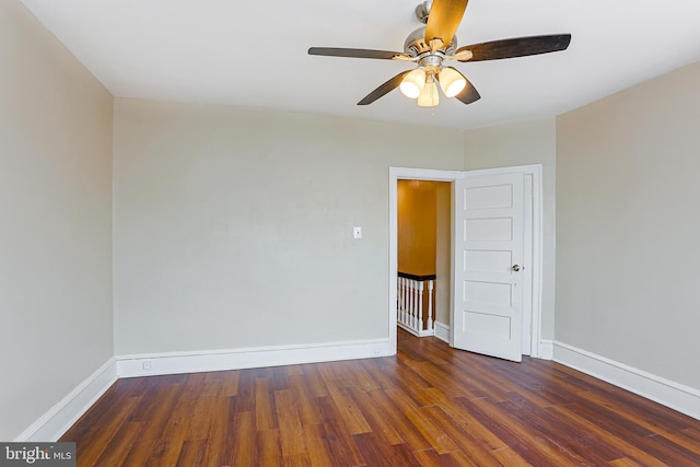 spare room with ceiling fan and dark hardwood / wood-style floors