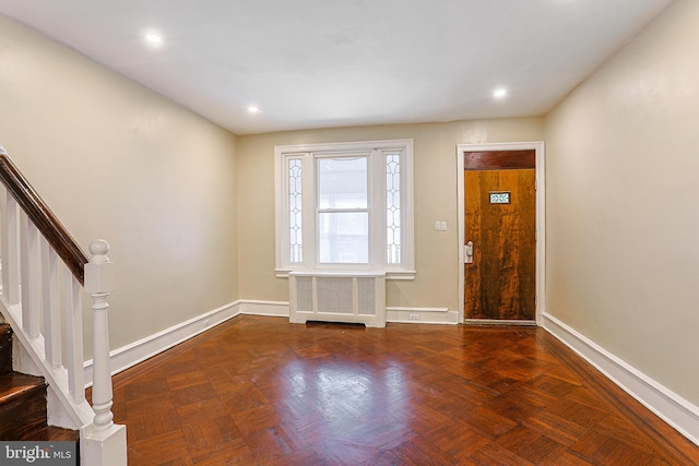 entryway featuring radiator and dark parquet floors