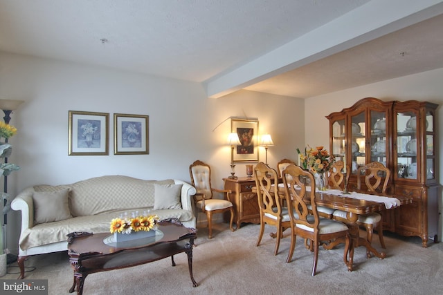 living room featuring light carpet and beamed ceiling