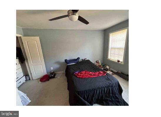 carpeted bedroom featuring ceiling fan