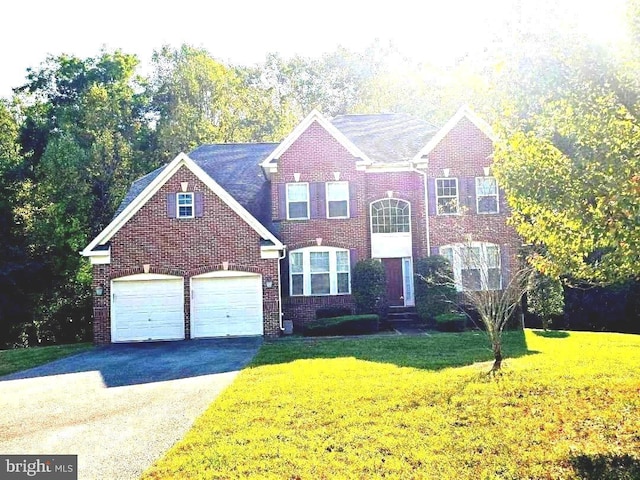 view of front of house featuring a front lawn and a garage