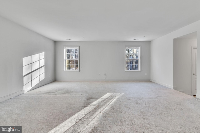 unfurnished room with light carpet