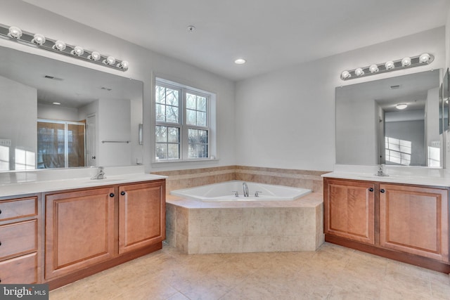 bathroom featuring tile patterned flooring, independent shower and bath, and vanity