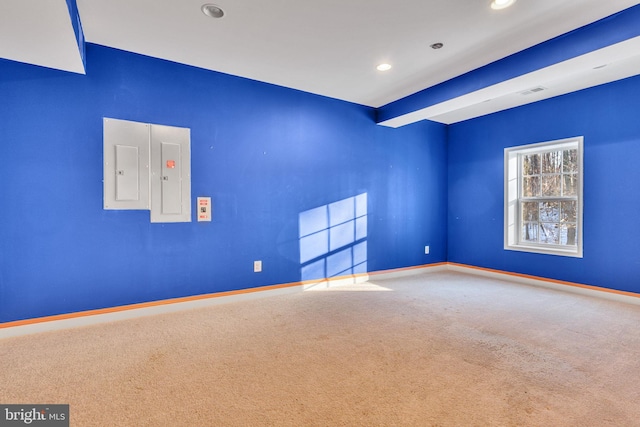 carpeted spare room featuring electric panel