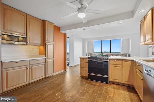 kitchen with ceiling fan, appliances with stainless steel finishes, dark wood-type flooring, and light brown cabinetry