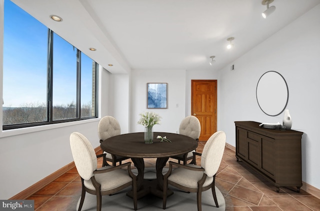 dining space with dark tile patterned flooring