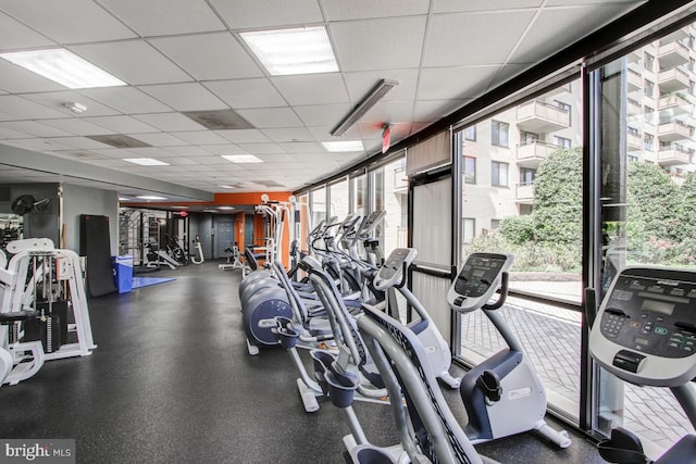 gym with a paneled ceiling