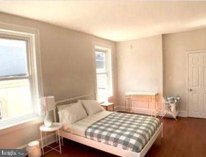 bedroom featuring dark wood-type flooring