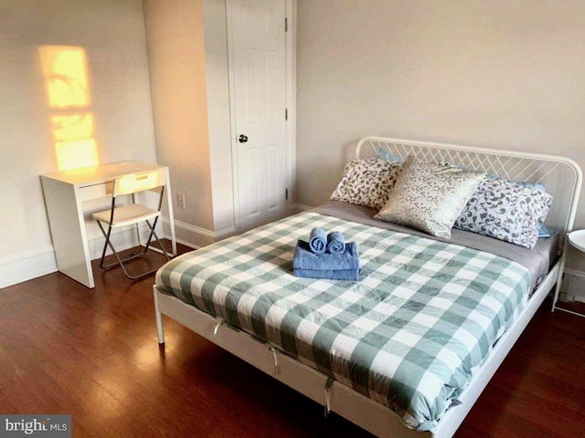 bedroom featuring dark hardwood / wood-style flooring