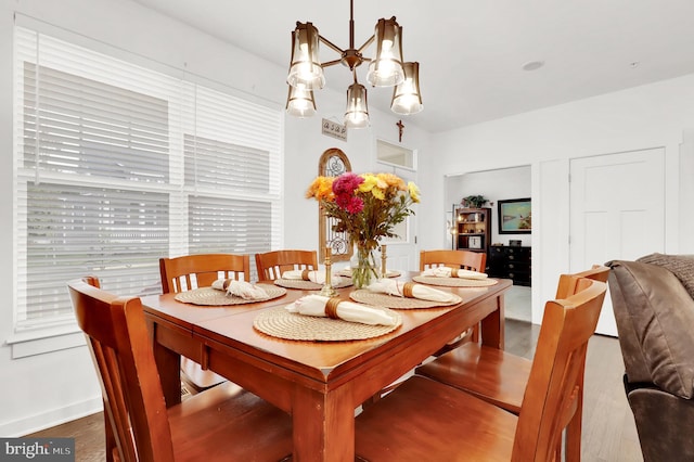 dining space featuring a notable chandelier and dark hardwood / wood-style flooring