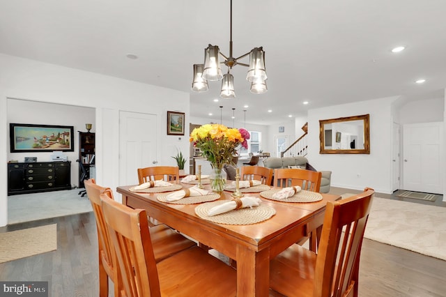 dining area with a chandelier and dark wood-type flooring