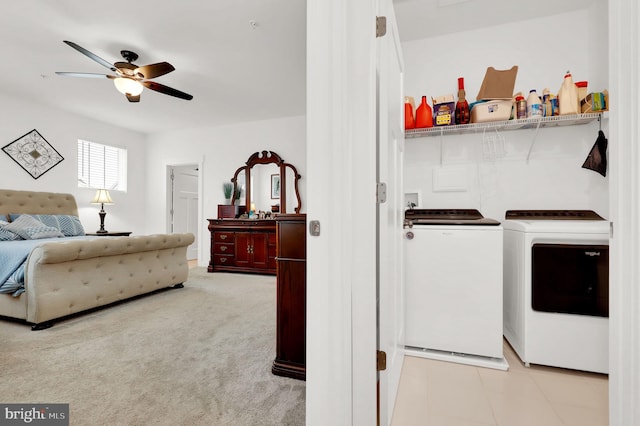 clothes washing area with ceiling fan, washer and dryer, and light colored carpet