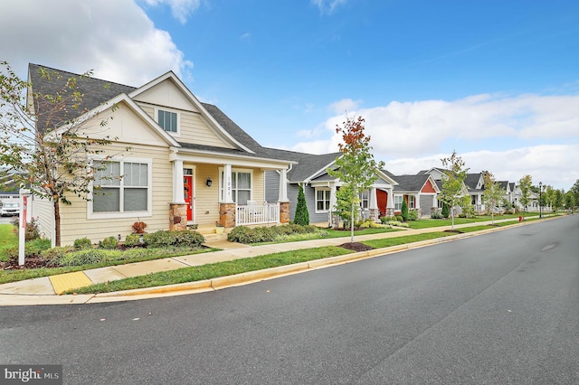 craftsman-style home with a front yard and a porch