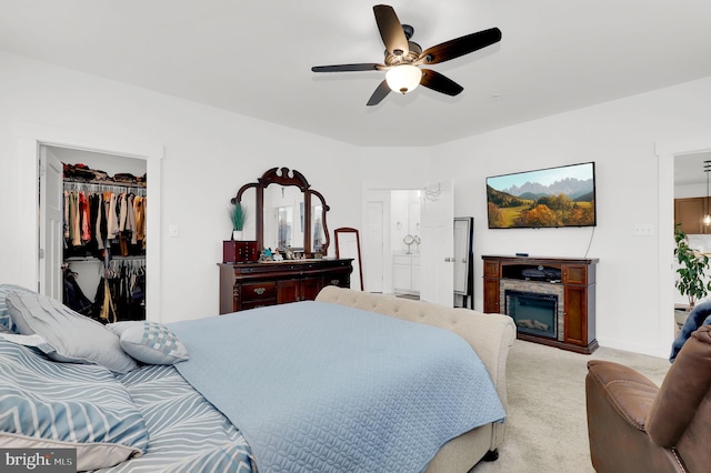 bedroom featuring ceiling fan, a closet, and light carpet