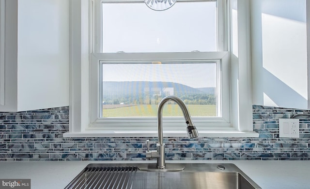 room details with sink and tasteful backsplash