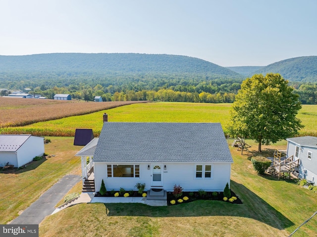 view of front of house featuring a mountain view, a rural view, and a front yard