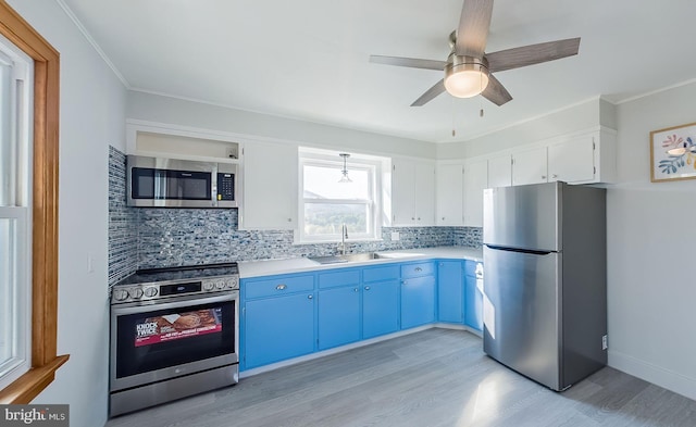 kitchen featuring sink, white cabinetry, stainless steel appliances, blue cabinets, and ceiling fan