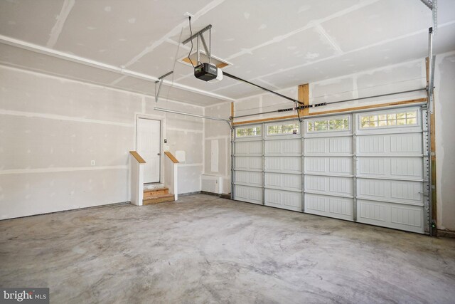 unfurnished room with dark carpet, ceiling fan, and a skylight