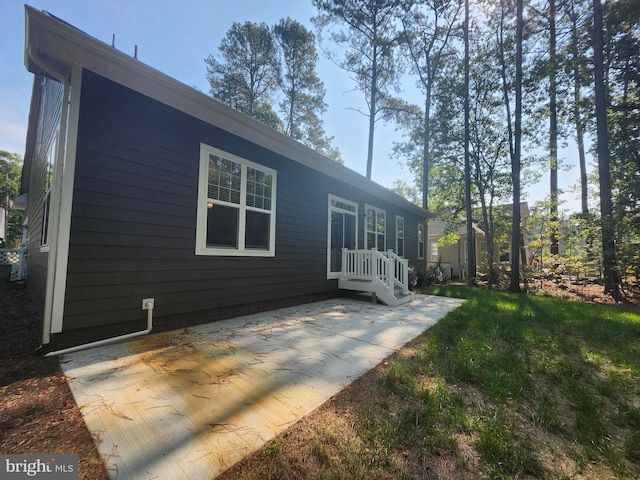 view of side of property with a patio area