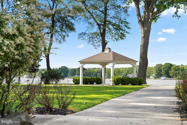 view of property's community with a yard and a water view