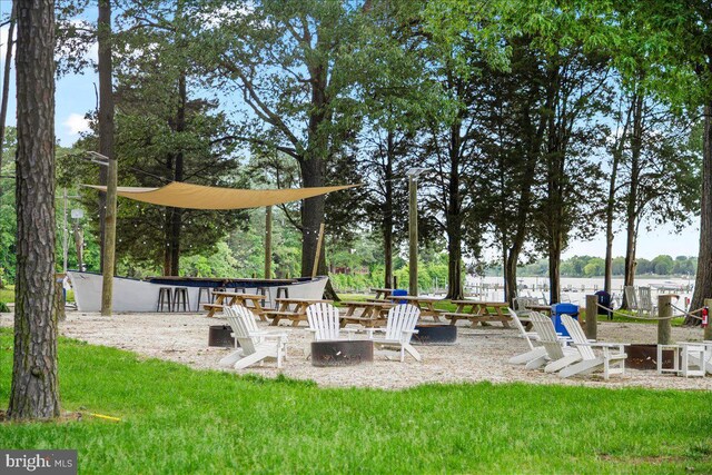 dock area featuring a yard and a water view