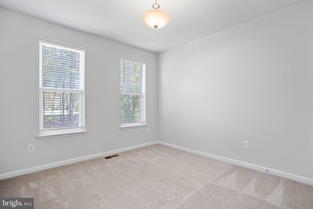 unfurnished living room with an inviting chandelier and dark hardwood / wood-style floors