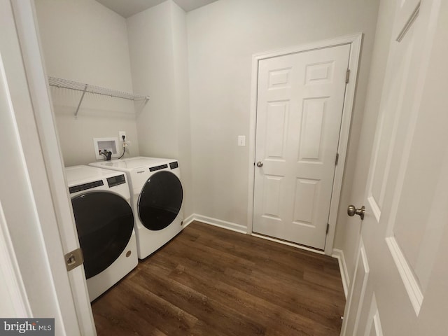 laundry area featuring washer and dryer and dark wood-type flooring