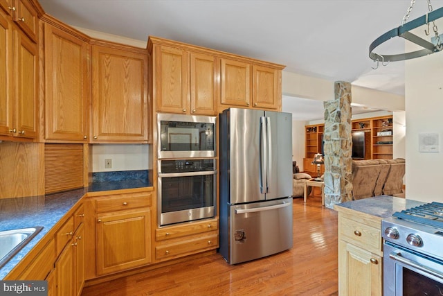 kitchen featuring stainless steel appliances and light wood-type flooring