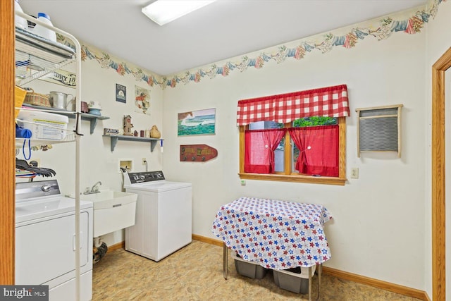 laundry room featuring washing machine and dryer and sink