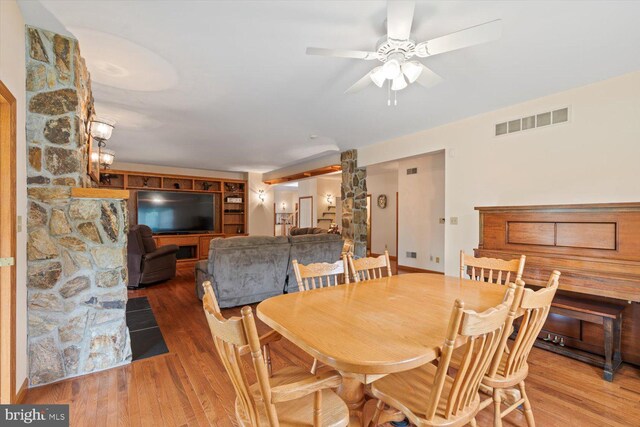 dining area with hardwood / wood-style floors and ceiling fan