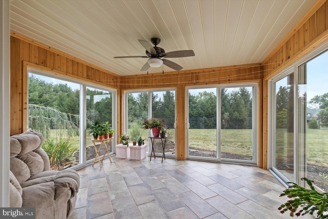 unfurnished sunroom with wood ceiling and ceiling fan