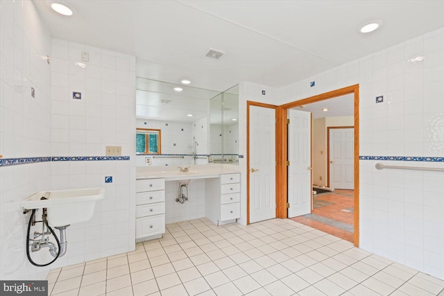 bathroom with tile walls and tile patterned floors