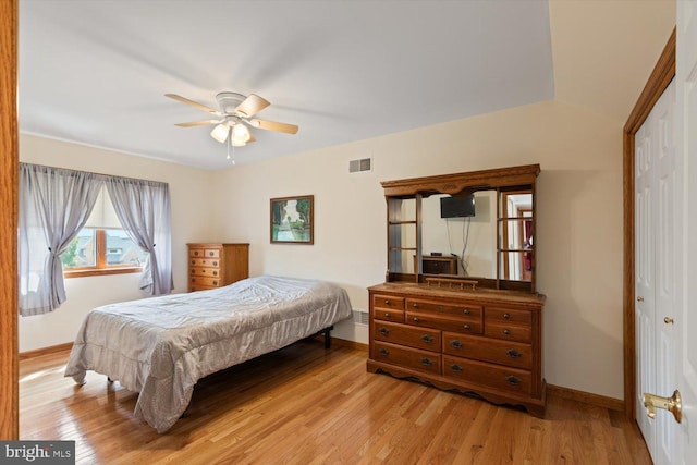 bedroom with ceiling fan, light hardwood / wood-style flooring, and a closet