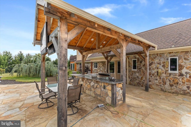 view of patio / terrace with exterior kitchen, a grill, and a gazebo