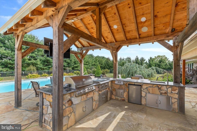 view of patio with an outdoor kitchen, a gazebo, and a grill