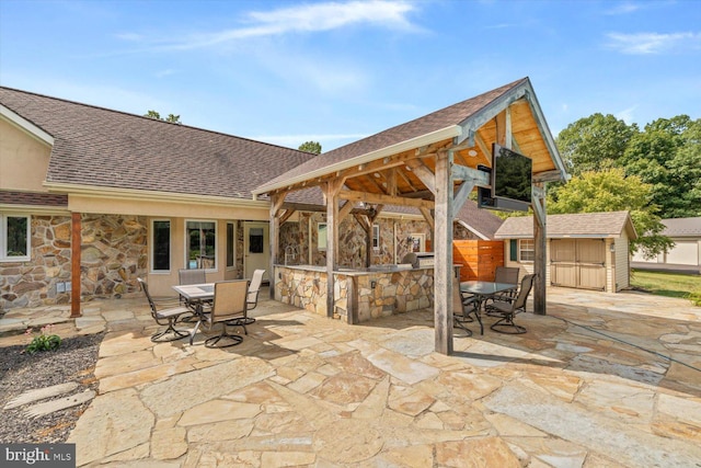 view of patio featuring a storage shed