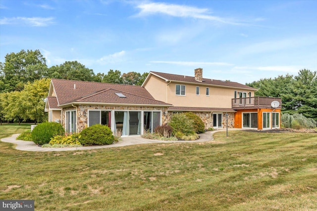 rear view of property featuring a lawn