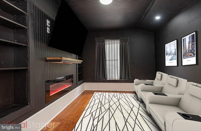 living room featuring lofted ceiling and hardwood / wood-style floors