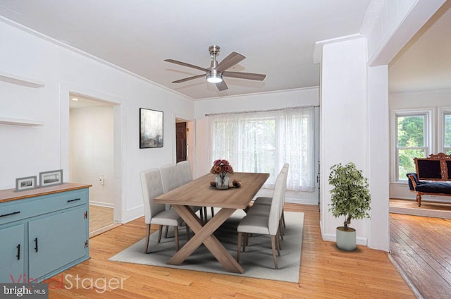 dining area featuring light hardwood / wood-style floors, ornamental molding, and ceiling fan