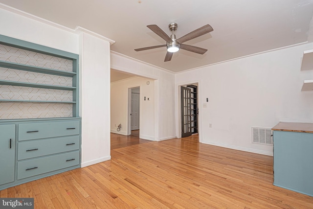 unfurnished living room featuring light hardwood / wood-style floors, ornamental molding, and ceiling fan