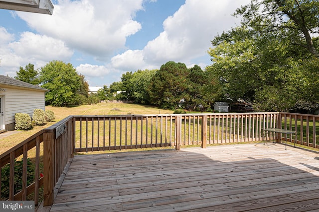 wooden terrace featuring a yard