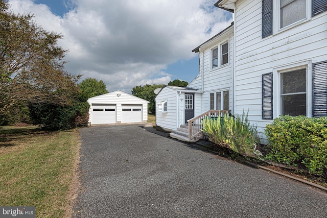 view of home's exterior with a garage and an outdoor structure