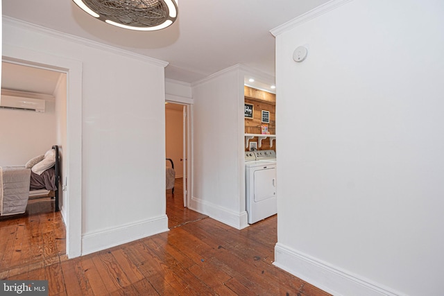 hallway featuring ornamental molding, a wall mounted air conditioner, dark wood-type flooring, and washer and dryer