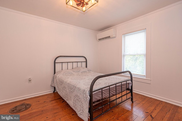 bedroom featuring wood-type flooring, crown molding, and a wall mounted air conditioner