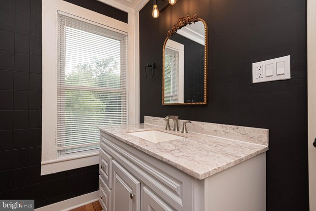 bathroom with vanity, hardwood / wood-style floors, and ornamental molding