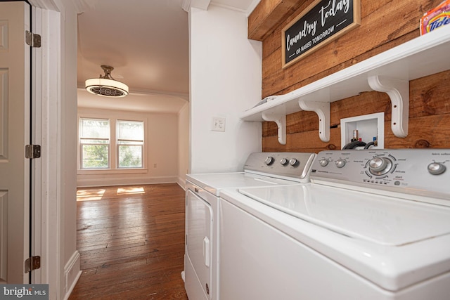 laundry area featuring washing machine and clothes dryer and dark wood-type flooring