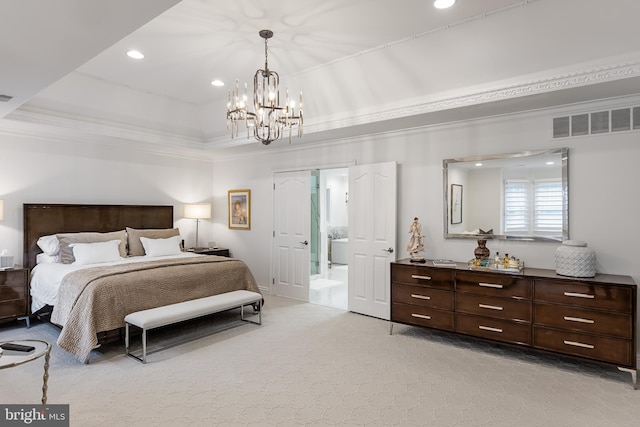 carpeted bedroom with ornamental molding, a tray ceiling, a notable chandelier, and ensuite bathroom