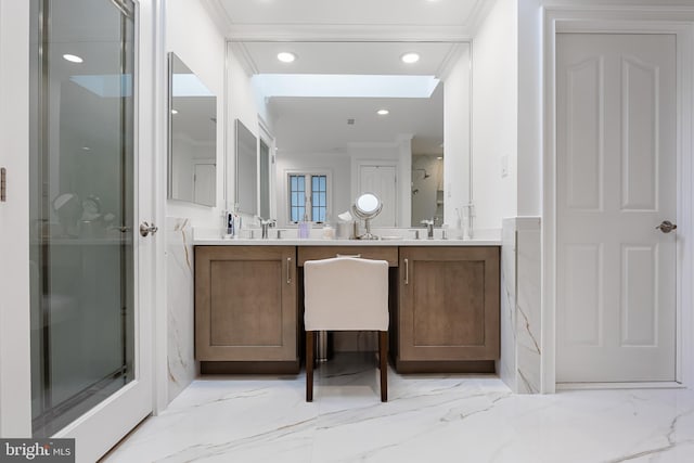 bathroom with a shower with shower door, vanity, and crown molding